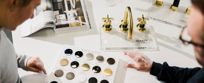 Customer + Longley employee looking at design inspiration for bathroom sinks